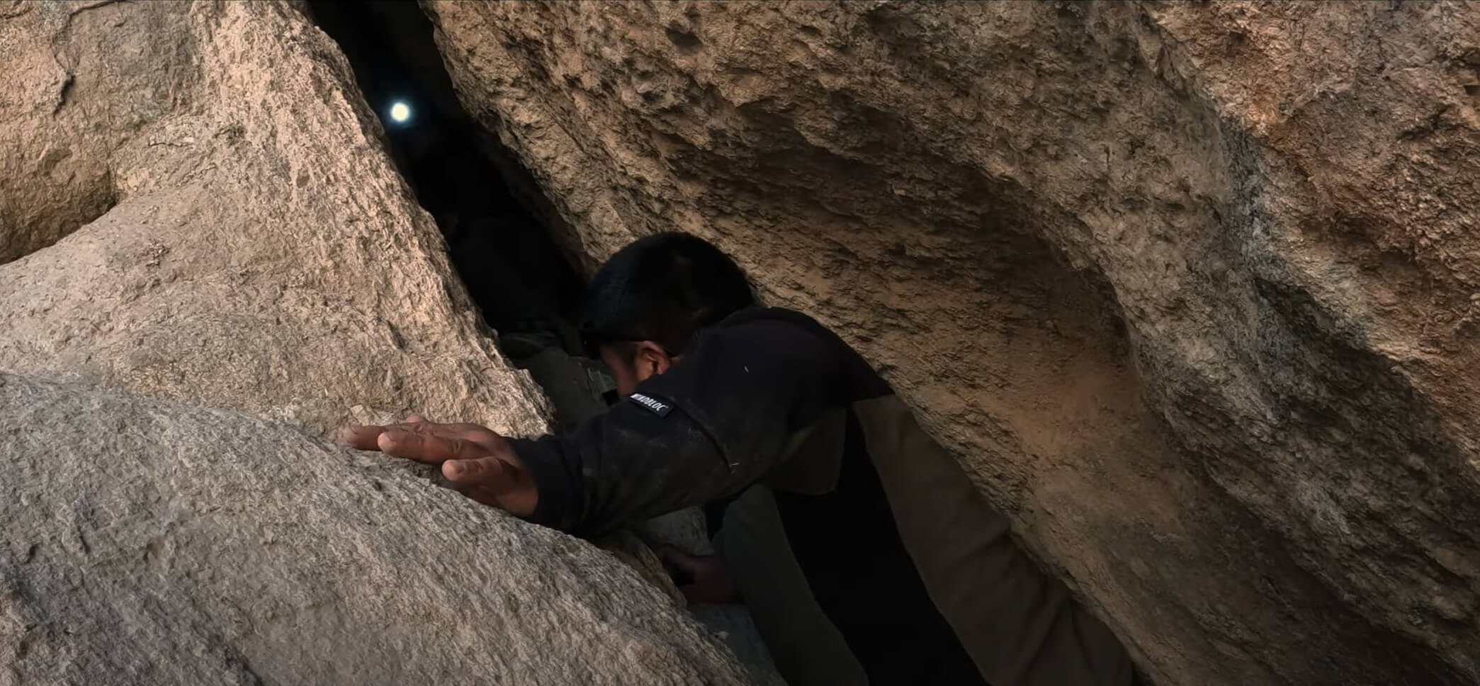 Harvesting shilajit between rocks at the himalayan mountain