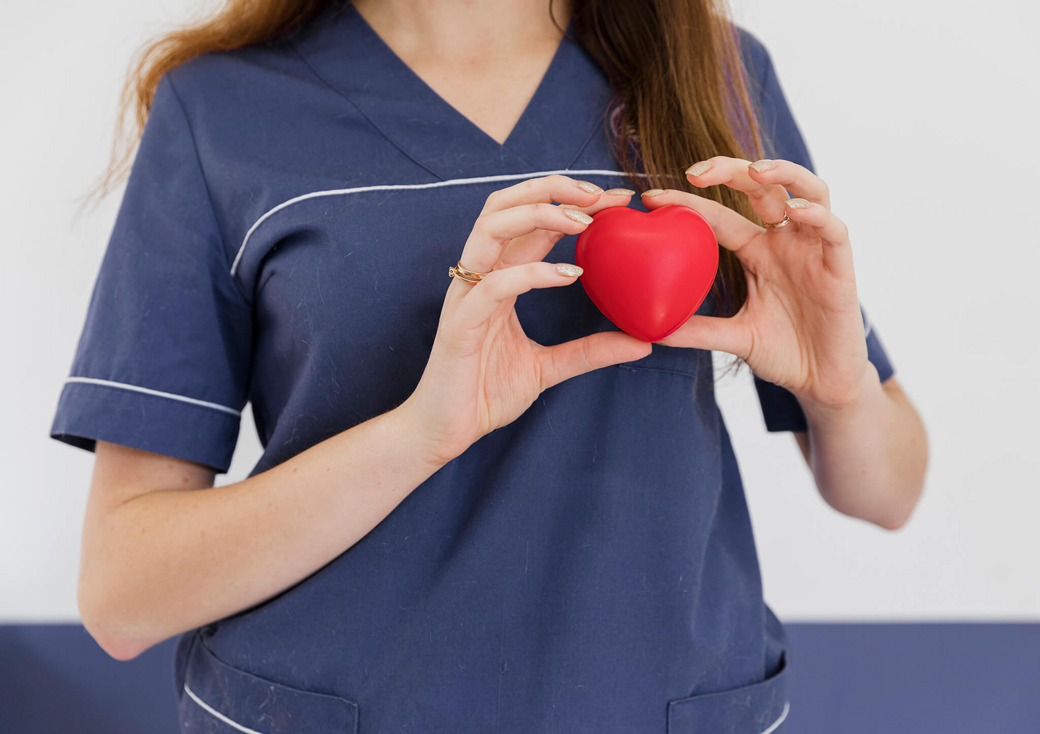 Doctor holding heart shaped toy