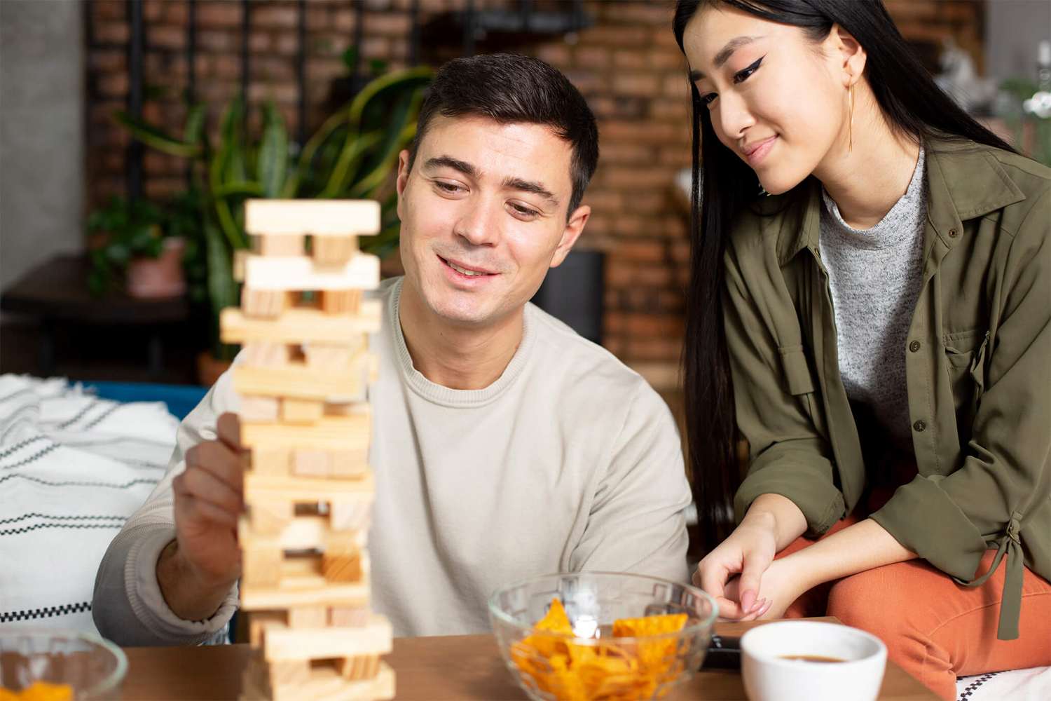 Friends having fun playing with Jenga